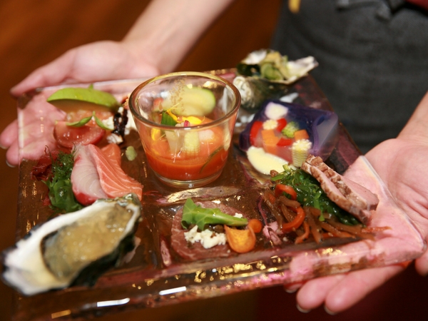 A delicious plate of oysters served natural, kilpatrick and with garnishes, finished with a wedge of lemon